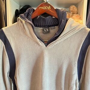 Grey hoody with navy collar and trim.